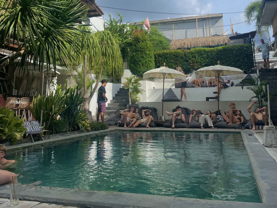 backpacker chilling around the pool at the farm hostel, canggu