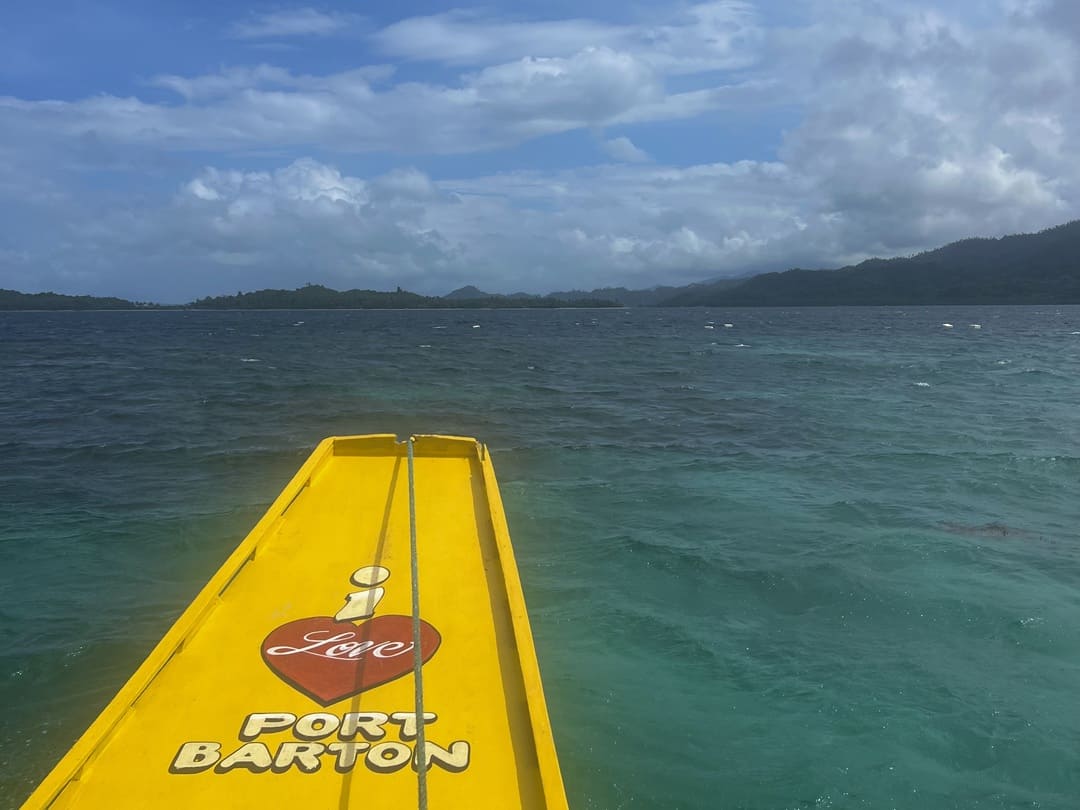 a tail of a boat saying 'i love port barton' in port barton, the philippines