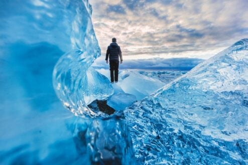 Man enjoying iceberg while travelling Iceland Ring Road