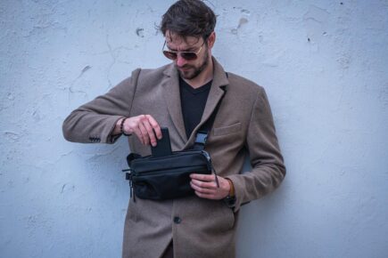 man carrying Aer Day black sling bag