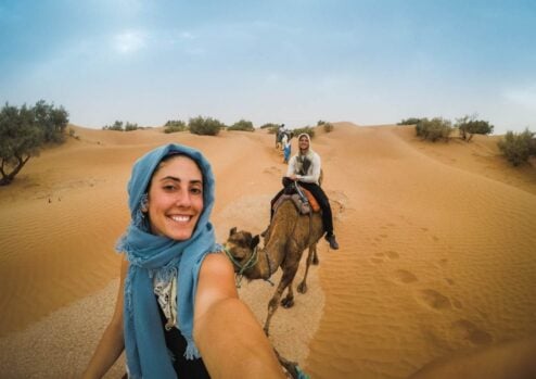 riding camels in sahara dessert morocco