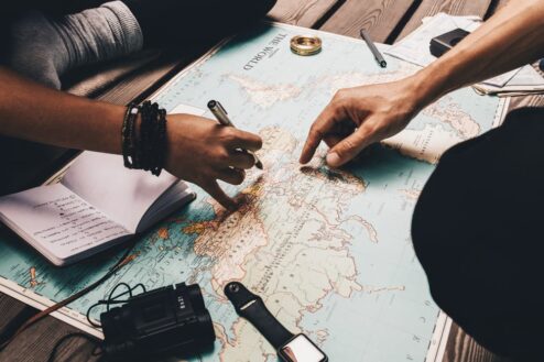 fingers pointing at a map planning a trip