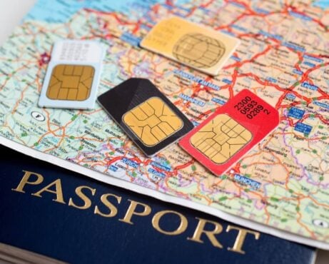 a map over a passport with sim cards on top of it