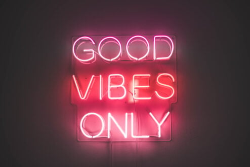 a neon sign reading good vibes only