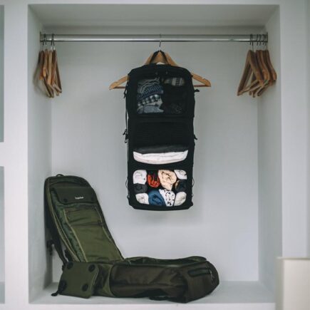 Shell Backpack By Tropicfeel with open organization bag inside wardrobe