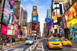 bright colors of time square seen while backpacking new york city