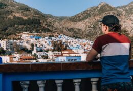 A person looking out over the blue city of Chefchaouen, Morocco
