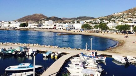 A picture of a marina with sailboats and beach