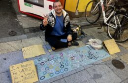 A vendor selling bracelets on the streets of Osaka to fund his travels.