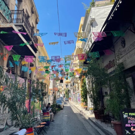 streets of plaka with colourful bunting and cafe tables along the streets