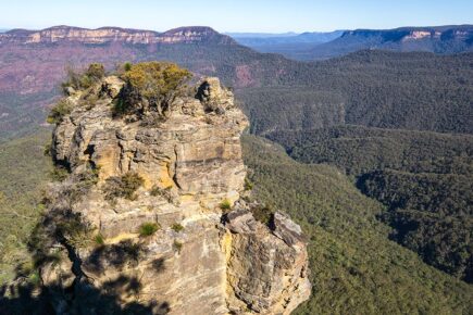 A rock formation and mountains in the distance in the Blue Mountains in New South Wales, Australia