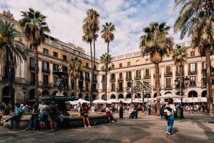 Royal square in Barcelona, Spain with palm streets and fountain with plenty of cafes