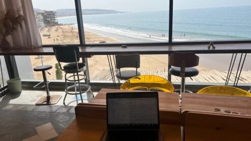 a laptop at a coworking space with the view of the ocean in morocco
