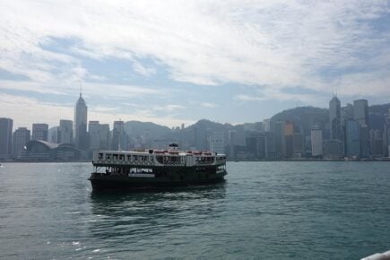 A Junk boat sailing across the harbour in Hong Kong, China