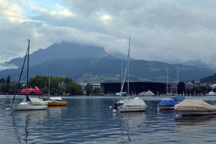 Cloud covered mountains with Lake Lucerne in the foreground in Lucerne, Switzerland