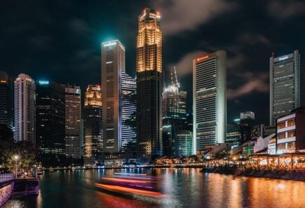 The Singapore skyline lit up at night from Clarke Quay.