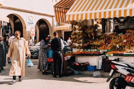 People shopping in a busy local market in Tangier, Morocco.