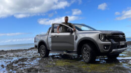 Will with a car on the beach in New Zealand