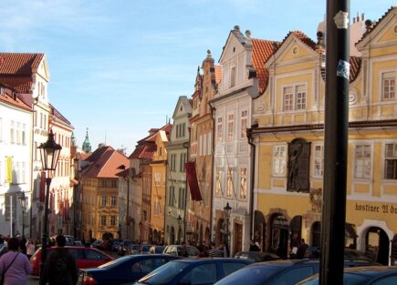 Looking down a street with pastel coloured traditional houses in Prague, Czech Republic