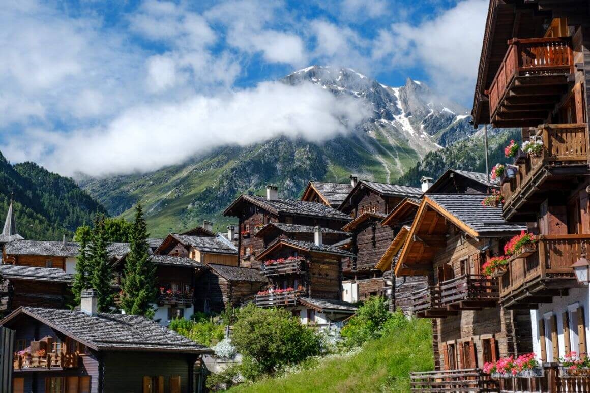 brown wooden houses and mountain during daytime