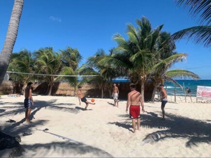 People playing football on the sand
